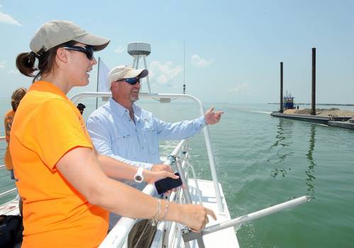 Rearchers point towards barge: Photo courtesy of Island Univ.