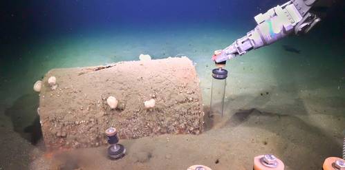 Researchers use Remotely Operated Vehicle SuBastian to collect sediment push cores next to barrels discarded on the seafloor. Credit: Schmidt Ocean Institute.