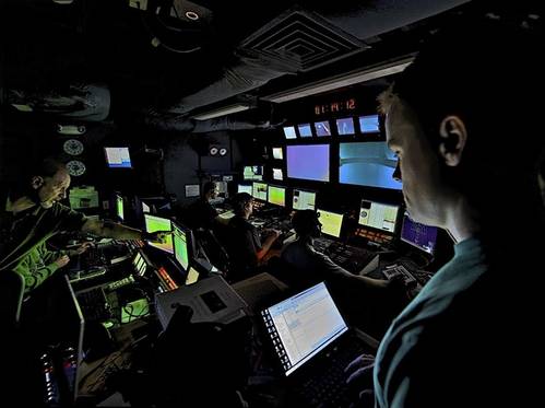 Scientists direct a remotely operated vehicle deep in the ocean from the mission control room aboard NOAA Ship Okeanos Explorer. (NOAA Okeanos Explorer team, INDEX-SATAL expedition)