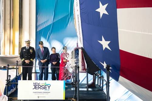 Ship's sponsor Susan DiMarco christens pre-commissioning unit New Jersey (SSN 796) during ceremony on Saturday, Nov. 13, 2021 at Newport News Shipbuilding. (Photo: HII)