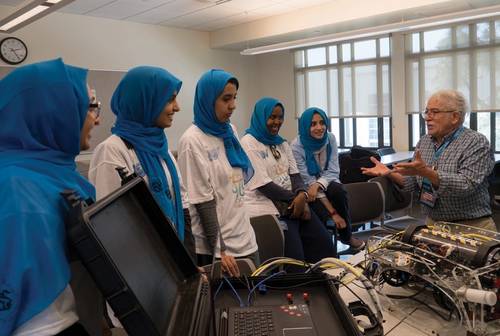Side scan sonar inventor and long-time MATE competition judge and supporter Marty Klein speaks to the all-female ROV team from Saudi Arabia during the 2017 international event. Photo courtesy MATE II