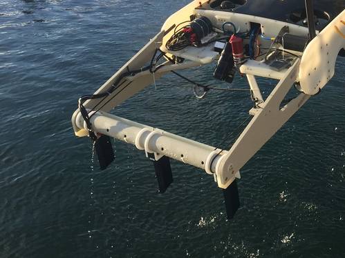 The Smartrak system deployed on the front of an AUV. The dark-colored Smartrak gradiometers can be seen mounted downwards on the white mounting frame. The sensors are fitted with fairings to reduce drag through the water. The AUV is flown close to the seabed during tasks. (Photo: INNOVATUM Ltd.)
