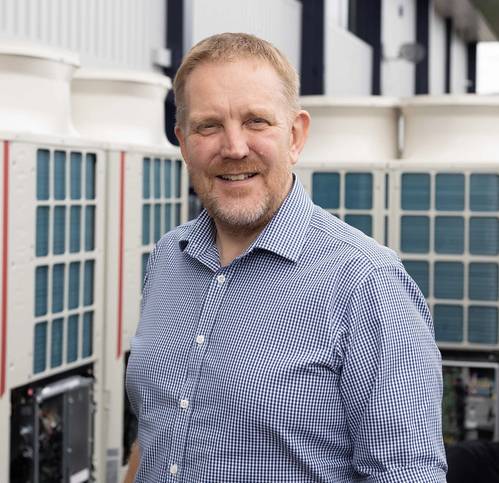 Sonardyne MD, Graham Brown, with some of the new electric heating and cooling system installed at the company HQ as part of the drive for sustainability. Credit: Sondardyne