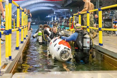 Teams enter the water at Naval Surface Warfare Center, Carderock Division's David Taylor Model Basin as they prepare for the 17th International Submarine Race in West Bethesda, Md., on June 29, 2023. (Photo: Aaron Thomas / U.S. Navy)