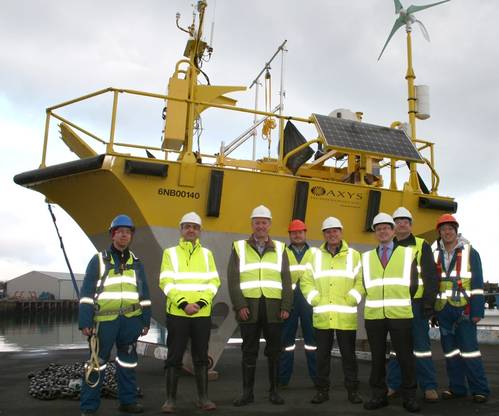 AXYS Technologies site engineering team show ORE Catapult's Chairman, Colin Hood, the first of the two dual-LiDAR WindSentinel floating LiDAR systems (Photo courtesy of AXYS Technologies)