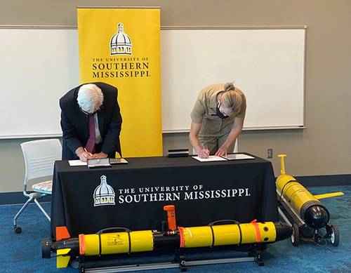 University of Southern Mississippi Vice President for Research Gordon Cannon, Ph.D, and Rear Adm. Nancy Hann, deputy director for operations for NOAA’s Office of Marine and Aviation Operations, sign an agreement to partner on using uncrewed systems to collect ocean data. Credit: NOAA