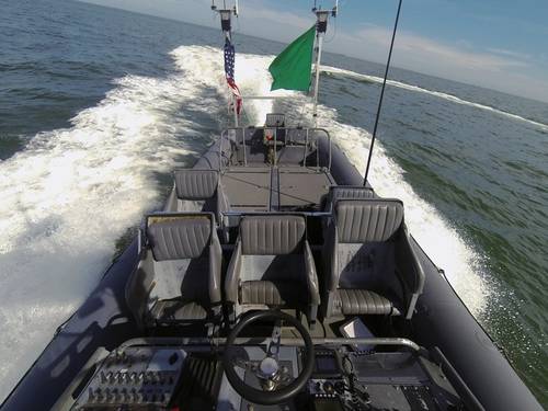 An unmanned rigid-hull inflatable boat operates autonomously during an Office of Naval Research (ONR)-sponsored demonstration of swarmboat technology held at Joint Expeditionary Base Little Creek-Fort Story. During the demonstration four boats, using an ONR-sponsored system called CARACaS (Control Architecture for Robotic Agent Command Sensing), operated autonomously during various scenarios designed to identify, trail or track a target of interest. (U.S. Navy photo by John F. Williams)