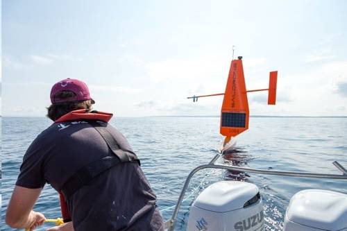 Vehicle assembly and service technician Josh Keller unties Saildrone 1084 from the tow line in Lake Michigan to deploy it for a 2023 U.S. Coast Guard Great Lakes Fisheries survey. (Photo: Saildrone)
