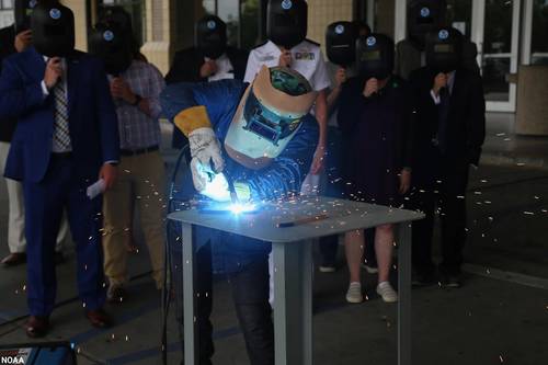 A welder from Thoma-Sea Marine Constructors, LLC, welds the initials of the Oceanographer's sponsor, Linda Kwok Schatz, wife of U.S. Sen. Brian Schatz of Hawaii, onto a steel plate that will be incorporated into the ship. (Photo: NOAA)