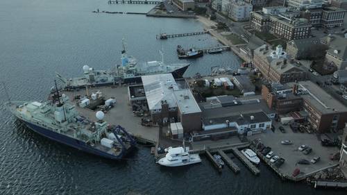 WHOI’s Iselin dock is the centerpiece of its waterfront facilities and home port to three research vessels along with test facilities, underwater vehicle labs and shops. (Photo by Stephanie Murphy, Woods Hole Oceanographic Institution)