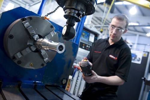 A Wireline employee working on a Roller Bogie Tool