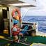 A marine technician hauls in the CTD (conductivity, temperature, and depth) rosette on a research cruise in the Sargasso Sea. © Maya Thompson