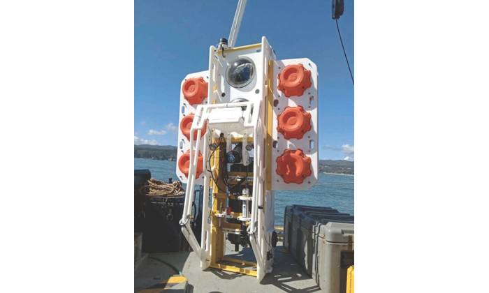 A hadal-class ocean lander, designed and built by the Universidad de Concepción (UdeC), Centro de Instrumentación Oceanográfica, is seen during buoyancy testing on the RV Kay-Kay in Dichato Bay, 38 kilometers north of the city of Concepción, in central Chile. The proximity and challenge of the Atacama Trench relentlessly draw UdeC engineers and scientists. Their ocean lander can downcast as a CTD-O in descent, remain in situ for extended periods on the trench floor, then upcast as a CTD-O/Rosett