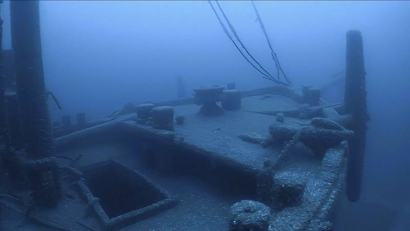 An anchor rests still attached on the bow of the sunken schooner barge Ironton, lost in a collision in 1894. Today the vessel sits upright and intact, all three masts still standing. Image Credit: NOAA Thunder Bay National Marine Sanctuary, Undersea Vehicles Program UNCW