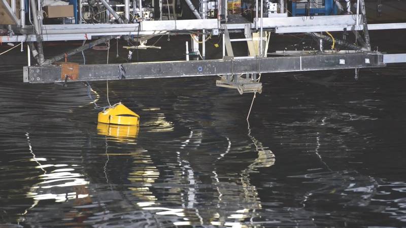 AquaHarmonics’ wave powered single point generator is demonstrated during an innovation showcase in the Maneuvering and Seakeeping Basin in Carderock, Md. (U.S. Navy photo by Heath Zeigler)