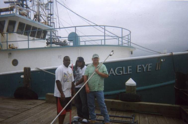 Captain Scott Drabinowicz with crew holding the tagging stick in front of the FV Eagle Eye II.
