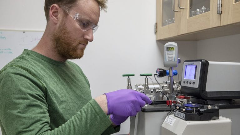 Collin Ward, a marine chemist at WHOI, works on polystyrene samples in his lab. Photo by Jayne Doucette, Woods Hole Oceanographic Institution