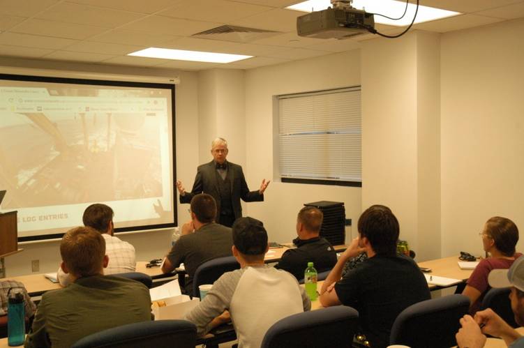 Command, Naval Meteorology and Oceanography Command Deputy Commander and Technical Director speaks to fifteen students at The University of Southern Mississippi at Stennis Space Center, Miss., where they are expected to be the first class in the nation to earn a certification in Unmanned Maritime Systems. (Photo: U.S. Navy)
