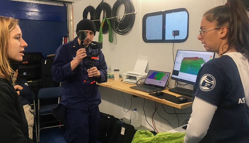 A key component of the expedition team’s daily work was education and outreach, shown here as team members broadcast live from the mission control van. Live broadcasts included direct connections to classrooms and through Facebook Live. You can view archived broadcasts through the Office of National Marine Sanctuaries’ Facebook page. (Photo: Ocean Exploration Trust)