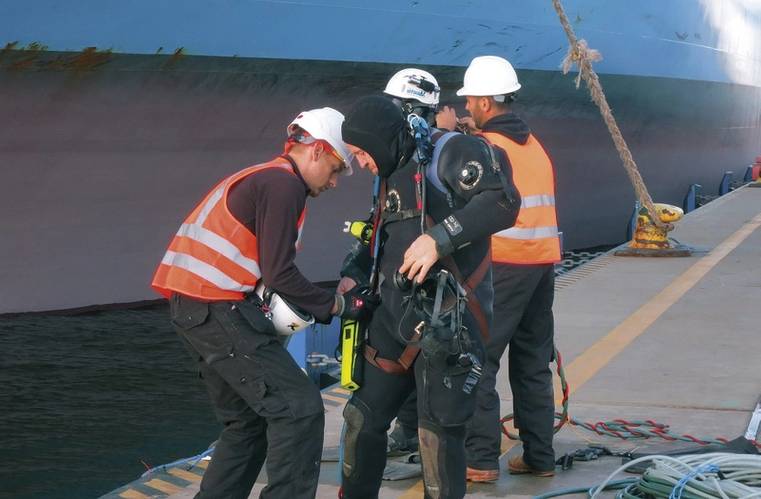 Divers getting ready for underwater operation.
