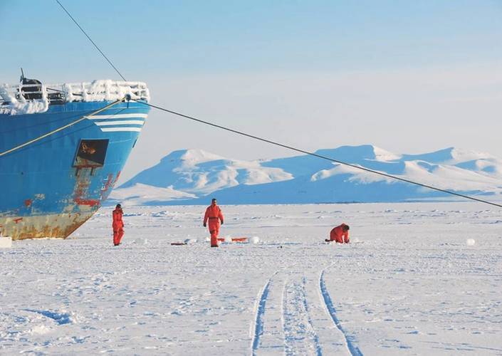 Field team collecting sea ice samples in pack ice in the Arctic Ocean. (Photo: C-CORE)