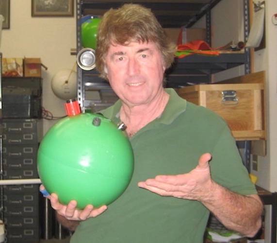 Figure 3.  The author with a 440Wh car battery that floats! (Photo by Brian Hardy, Global Ocean Design)