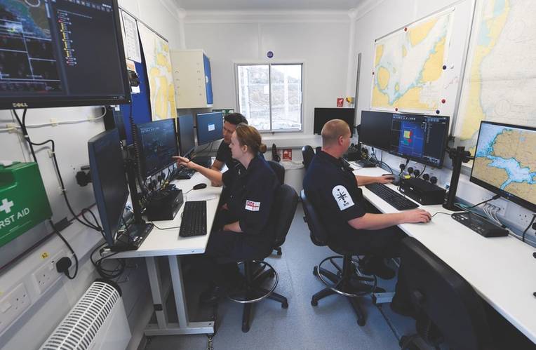 Figure 2: Mission Control at Unmanned Warrior. Each Royal Navy operator is monitoring a Neptune squad of multiple robots. (U.S. Navy photo by John F. Williams)