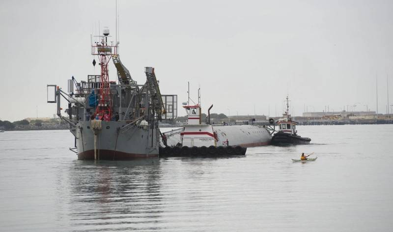 Tugs guide the Department of the Navy's Floating Instrument Platform (FLIP) from her berth at the Nimitz Marine Facility in Point Loma, Calif. (U.S. Navy photo by John F. Williams/Released)
