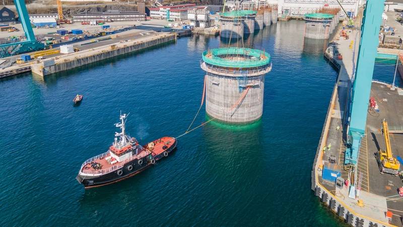 Hywind Tampen structures being floated out of the drydock at Stord, Norway. Photo from Aker Solutions / Lars Melkevik.