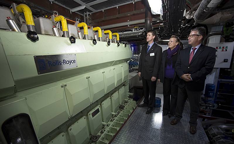 Inside the engine room, the Rolls-Royce team admire the Bergen gas engine> Project Manager Oscar Kallerdahl, Aila Lainio from our Rauma site where the thrusters are manufactured, and Ruediger Dube, VP Merchant, Europe, Middle East and Africa.