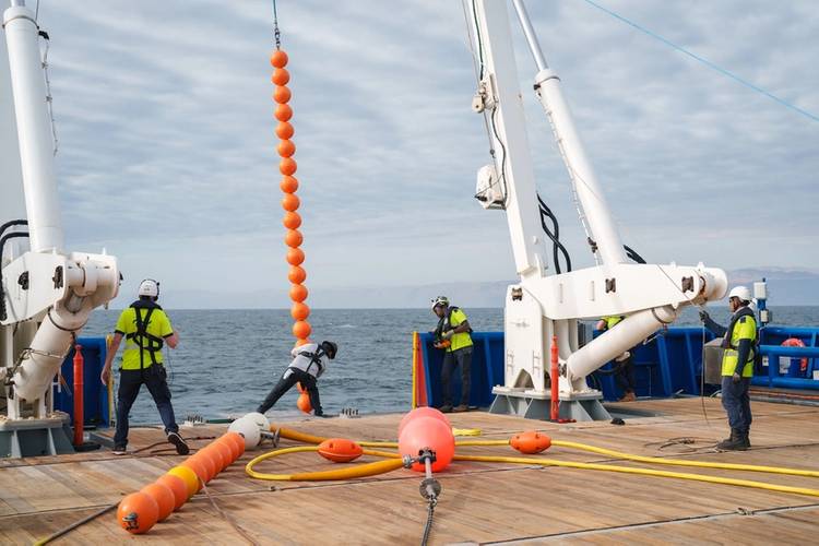 The in-situ 'Cocktail' incubator (Chamber Oxygen Collector Kit Tracer Analyser Insitu Logger) is recovered. First to be brought on board are a series of bright floats beneath which, a few hundred meters below, is the 'Cocktail' incubator. This specialized piece of equipment, built using titanium and glass allows the science team to monitor the activity of microbes in the water column at in situ oxygen, temperature and pressure. 
Credit: Alex Ingle / Schmidt Ocean Institute