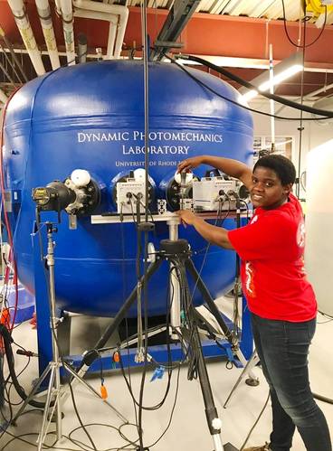Irine Neba Neba Mforsoh performing an experiment in Professor Arun Shukla’s Dynamic Photomechanics Laboratory at URI. (Photo courtesy of Irine Neba Neba Mforsoh)