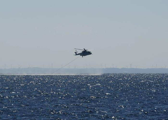 A JMSDF MCH-101 mine warfare helicopter rakes for mines in Mutsu Bay during 2JA 2017 Mine Countermeasures Exercise (2JA-17 MCMEX). 2JA Mine Countermeasures Exercise is an annual bilateral exercise held between the U.S. Navy and Japanese Maritime Self Defense Force to strengthen interoperability and increase proficiencies in mine countermeasure operations. (Photo by William McCann)