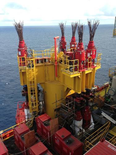 Mammoet strand jacks and power packs installed on the platform legs. (Photo: Mammoet)