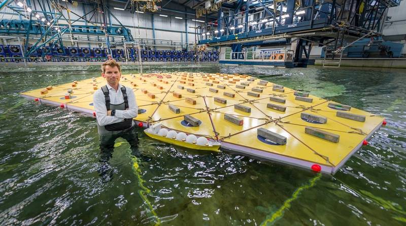 MARIN's Olaf Waals pictured with the scale model of a mega floating island in its Offshore Basin in a storm of waves, wind and currents. (Images: MARIN)