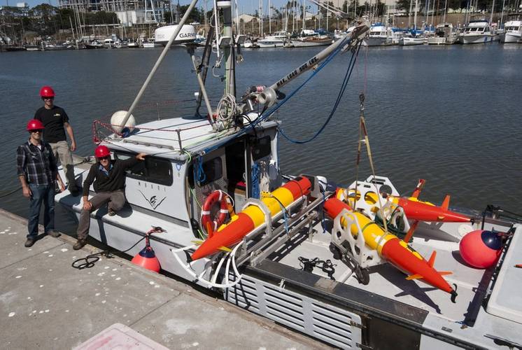 MBARI engineers Ben Yair Raanan, Brian Kieft, and Brett Hobson prepare to deploy three long-range autonomous underwater vehicles from the Research Vessel Paragon in Monterey Bay. (Credit: Todd Walsh © 2014 MBARI)