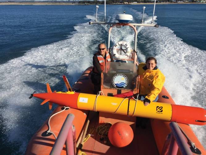 MBARI researchers head out into Monterey Bay to deploy a long-range autonomous underwater vehicle (LR-AUV), an underwater robot that is programmed at the surface and then travels underwater for hundreds of miles, measuring water chemistry and collecting water samples as it goes.  Credit: Brian Kieft (c) 2015 MBARI