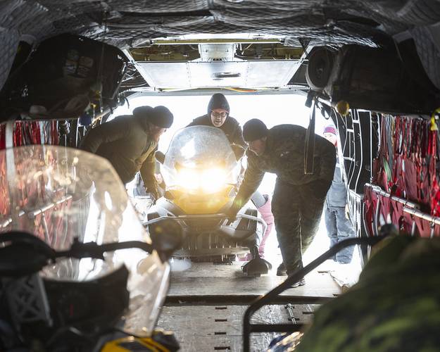 Members of 1 Canadian Ranger Patrol Group and Sergeant Andrew Deutsch of the CH-147F Chinook crew loading a snowmobile to prior to takeoff to the Ski Landing Area (SLA) camp as part of Operation NANOOK-NUNALIVUT in Inuvik NWT. 
Credit: Corporal Jacob Hanlon, Canadian Forces Photo
