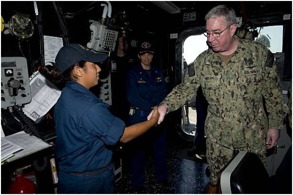 Vice Adm. John W. Miller congratulates Boatswain's Mate Seaman Erika Miranda Alvarez on her selection as Carrier Strike Group (CSG) 11's Blue Jacket of the Quarter aboard the guided-missile destroyer USS William P. Lawrence (DDG 110). (U.S. Navy photo by Carla Ocampo)