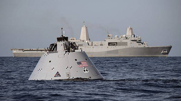 A mock-up capsule designed to simulate the Orion crew module that will splash down in the Pacific Ocean following Exploration Mission-1 planned for Dec. 2019. In the background: USS Anchorage is supporting NASA's Underway Recovery Test. (U.S. Navy photo by Abe McNatt)