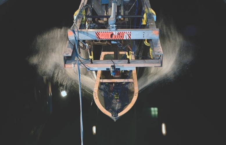 A ship hull model attached to a high-speed sled moves through waves at the David Taylor Model Basin at Naval Surface Warfare Center, Carderock, during ONR-sponsored research. (U.S. Navy photo by John F. Williams)
