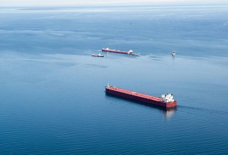 The motor vessel Edgar B. Speer safely passes the safety zone around the motor vessel Roger Blough and responders near Gros Cap Reefs Light in Lake Superior, May 30, 2016. (U.S. Coast Guard photo by Christopher Yaw)