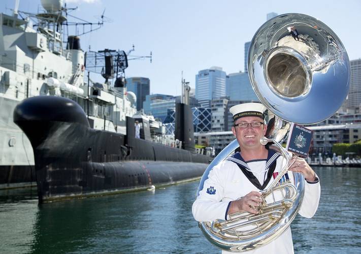 Musician Leading Seaman Martyn Hancock who composed the musical piece "March of the Silent Service" stands in front of decommissioned submarine HMAS Onslow at the Australian National Maritime Museum, Darling Harbour, Sydney. (Photo: Tom Gibson)