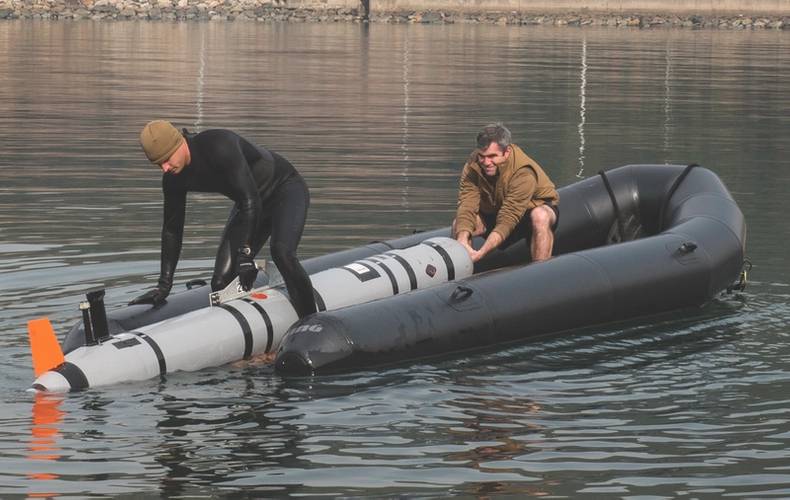 U.S. Navy Lt. j.g. Jeff Morehead (left) and Electronics Technician 2nd Class William Stark, with Explosive Ordnance Disposal Mobile Unit (EODMU) 5, pull a MK18 Mod 2 unmanned underwater vehicle onto a tow sled at Jinhae-gu, Republic of Korea (ROK) March 31, 2016 during exercise Foal Eagle 2016. (U.S. Navy photo by Charles E. White)