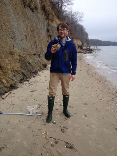 Neil Kelley, a Peter Buck postdoctoral fellow at the Smithsonian’s National Museum of Natural History, holds a fossil stingray spine found during a recent expedition to Calvert Cliffs, MD. (Photo by Nicholas Pyenson, Smithsonian Institution)