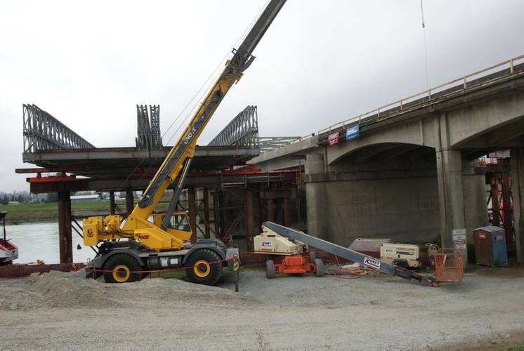 Northwest-based Omega Morgan won a bid to jack up 915-ton span and then slid it onto steel columns for the Skagit River Bridge in Washington State. This photo is of the bridges after the new span was jacked down into place. The jack-and-slide method meant traffic could get moving more quickly.  The Skagit Bridge made national news when a truckload hit several crossbeams, causing it to collapse and putting a spotlight on thousands of aging bridges across the nation. (Photo courtesy Omega Morgan.)