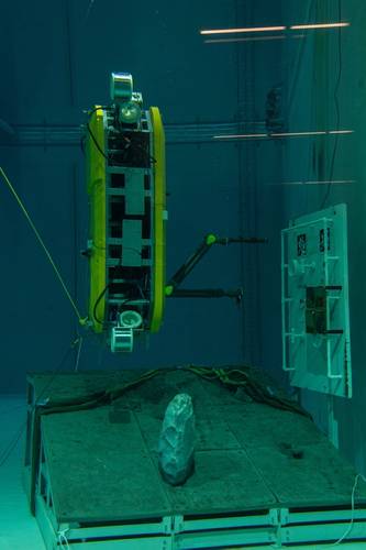 The AUV performs manipulation tasks on an underwater mockup in an upright position. Photo Copyright: DFKI, Thomas Frank