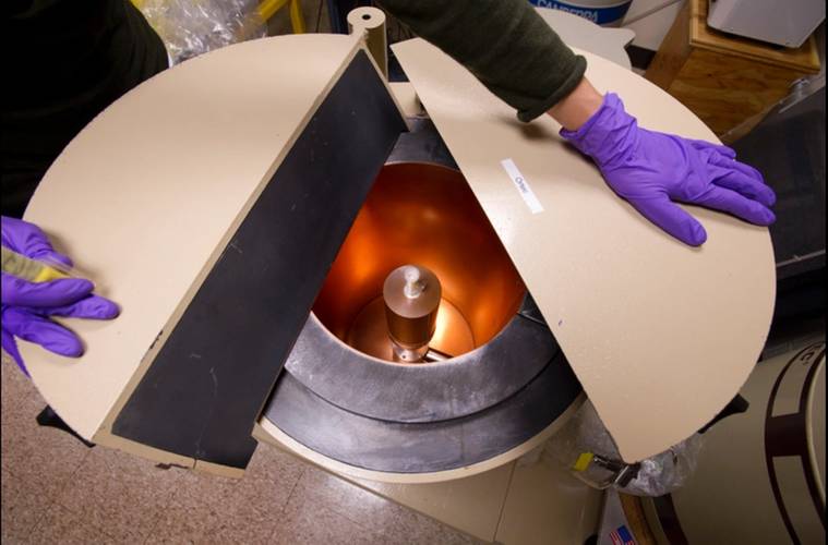 Prepared sample from Fukushima being inserted into lead-lined gamma well detector. (Photo by Tom Kleindinst, Woods Hole Oceanographic Institution)