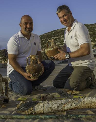 Project co-Directors Theotokis Theodoulou and Brendan Foley compare ceramic containers recovered from the Antikythera Shipwreck. (Photo by Brett Seymour, EUA/WHOI/ARGO)