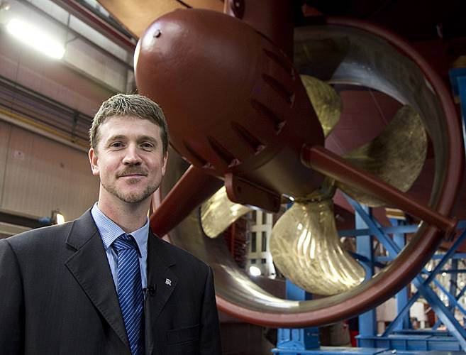 Project Manager, Oscar Kallerdahl stand beneath the second LNG tug, which will be delivered early next year.